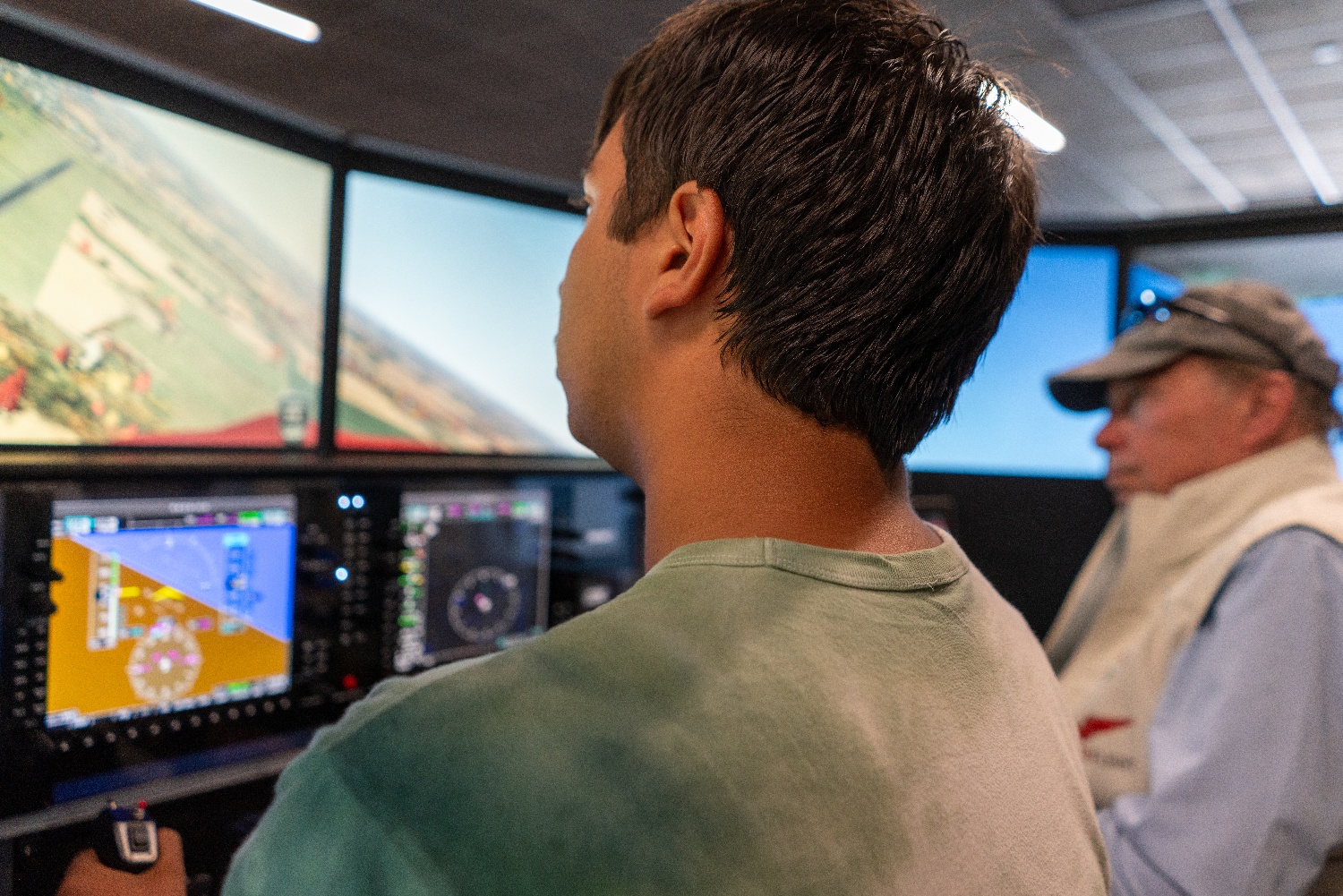 Student pilot and flight instructor training on a Redbird flight simulator